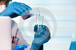 Chemist working in laboratory mixing fluids