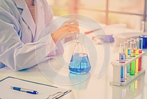 Chemist works at the laboratory, morning room has sunlight shining through, With test specimens working photo