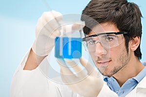 Chemistry experiment - scientist in laboratory photo