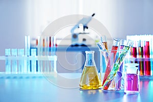 Chemistry glassware with liquids on table in laboratory