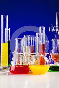Chemistry lab set with colored chemicals in it on a table over b