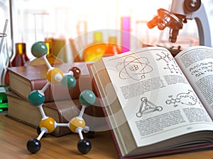 Chemistry .Laboratory equipment microscope with flasks, vials and model of molecule and book of chemistry