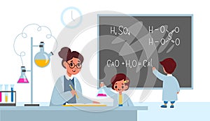 Chemistry lesson. Students in classroom interior with teacher, boy writes formulas on school blackboard, girl with flask