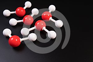 Chemistry model atom of molecule water scientific elements. Integrated particles hydrogen and oxygen atom on black background.