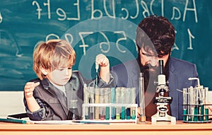 Chemistry and physics biology. Wisdom. Back to school. son and father at school. Flask in scientist hand with Test tubes