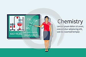 Chemistry teacher with pointer standing in front of blackboard