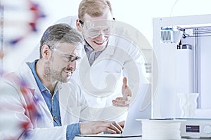 Chemists with laptop and printer