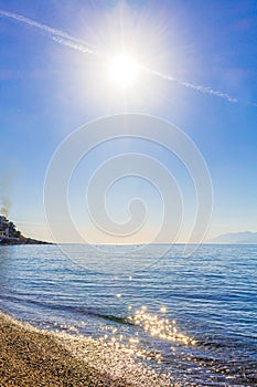 Chemtrail cross the sun above the beach Kos island Greece