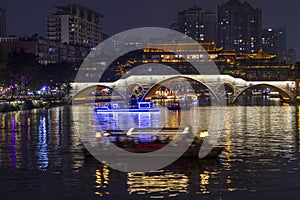 Illuminated bridge reflected in the river in Chengdu, China.