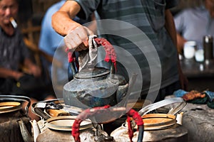 Man holding an old kettle in a chinese ancient tearoom