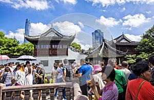 Chenghuangmiao street with travelers and pagoda style buildings.