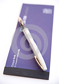 Cheque book and pen.