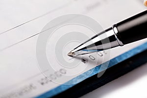 Woman`s Hand Writing a Check - Close Up