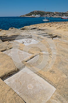 Chequerboard of rock-cut saltpans on the shoreline in Malta, Gozo