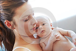 Cherishing the moment. Closeup shot of a mother holding her newborn baby.