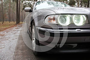 Chernigov, Ukraine - January 6, 2021: Old car BMW 7 Series E38 on the road in the forest. Gloomy weather