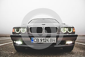 Chernigov, Ukraine - January 6, 2021: Old car BMW 7 Series E38 on the road against a background of fog. Gloomy weather. Bmw and