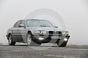 Chernigov, Ukraine - January 6, 2021: Old car BMW 7 Series E38 on the road against a background of fog. Gloomy weather. Bmw and