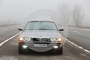 Chernigov, Ukraine - January 6, 2021: Old car BMW 7 Series E38 on the road against a background of fog. Gloomy weather. Bmw and