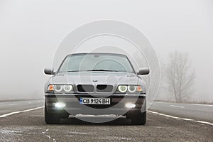 Chernigov, Ukraine - January 6, 2021: Old car BMW 7 Series E38 on the road against a background of fog. Gloomy weather. Bmw and