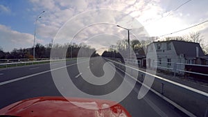 Chernihiv, Ukraine. 3 apr 2019. Red race car cruising through the highway at middle spring day