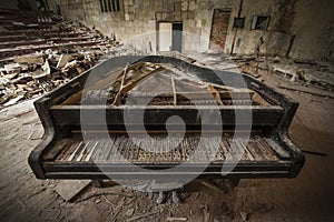 Chernobyl - close-up of an old piano in an auditorium