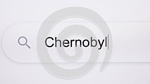 Chernobyl - Internet browser search engine bar typing Soviet Union 1986 nuclear disaster. Typing the word Chernobyl in