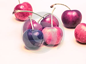 Cherries with artificial, surreal, unnatural, look isolated on bright background.