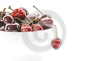 Cherries in bowl. Closeup of Fresh cherries isolated on white background.