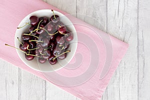 Cherries in a Bowl on Pink and White Wood