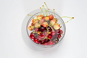 Cherries. Cherry. Cherries in color bowl and kitchen napkin. Red cherry. Fresh cherries. Cherry on white background.