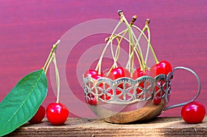 Cherries with cuttings in an iron vintage mug