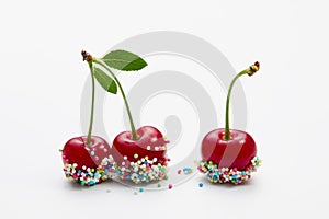 Cherries decorated with colorful candy sprinkles