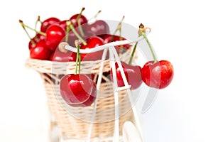 Cherries in decorative basket on a bicycle, isolated