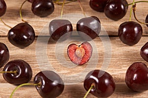 Cherries are diffuse on a wooden background photo