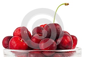 Cherries fruits in a glass bowl isolated on white background