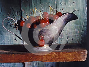 Cherries in a gravy boat photo