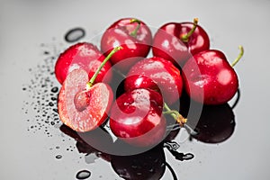 Cherries on gray background. Fresh ripe Cherry berries close-up. Organic red cherries with water drops