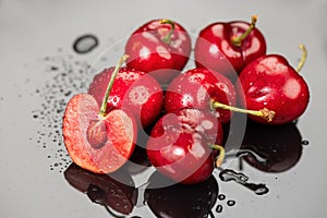 Cherries on gray background. Fresh ripe Cherry berries close-up. Organic red cherries with water drops