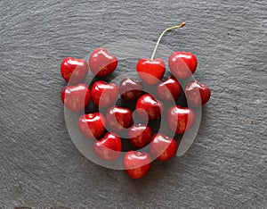 Cherries heart on a grey slate