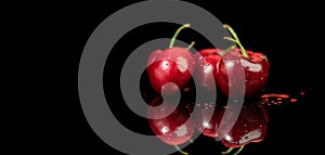 Cherries isolated on black background. Fresh ripe Cherry close-up. Organic red cherries isolated on black