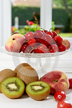 Cherries, kiwis and peaches in a glass cup