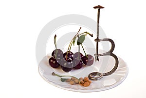 Cherries and pitter on plate