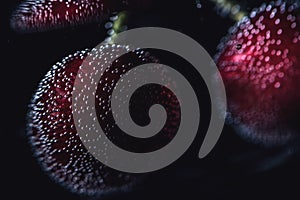 Cherries in a sparkling water, close up, macro photography