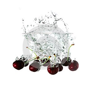 Cherries splash on water, isolated on white background