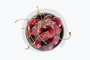 Cherries with stalks. Cherry in bowl isolated on white background. Top view