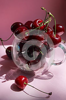 Cherries in transparent bowl, pink background. Red cherry. Fresh cherries. healthy food concept