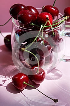 Cherries in transparent bowl, pink background. Red cherry. Fresh cherries. healthy food concept