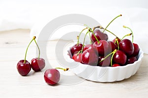 Cherries in white bowl. Cherry on white background. - healthy eating and food concept