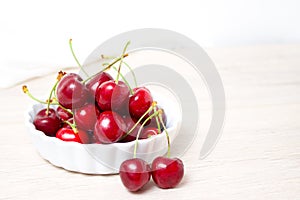 Cherries in white bowl. Cherry on white background. - healthy eating and food concept